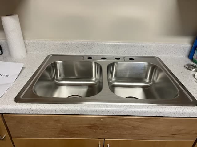 new stainless double sink being installed