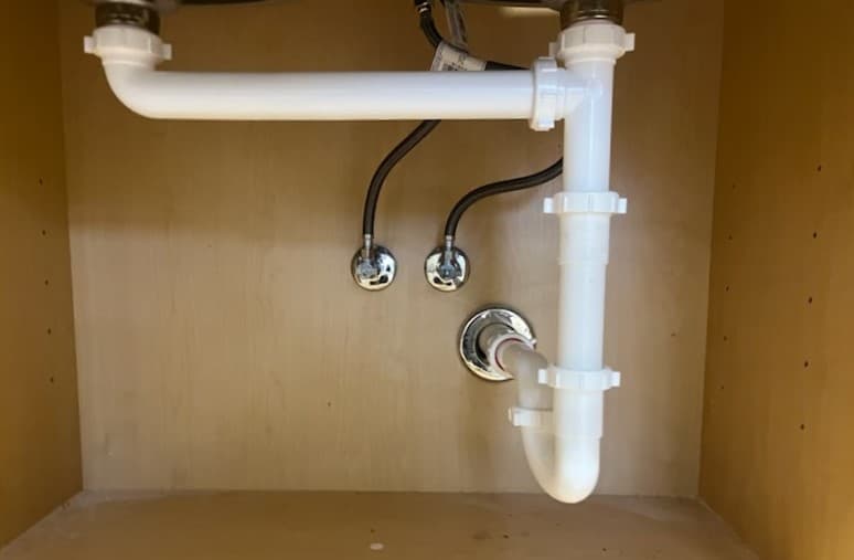 Newly installed pvc piping under a sink  